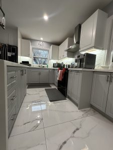 TDM's Deacon Cabinet Door Fronts in matte finishes Nordic White and Dove Grey are featured in a modern kitchen reface.