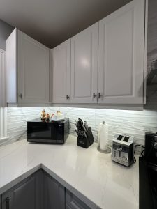 The Door Maker's Deacon Cabinet Doors in a contemporary kitchen in two matte finishes, Nordic White and Dove Grey.