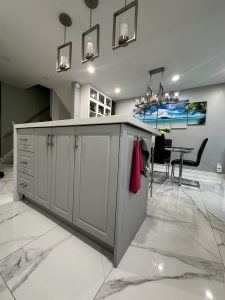 TDM's Deacon Cabinet Doors and matching Panels in Dove Grey matte finish in modern kitchen island.